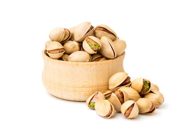 pistachio-nuts-wooden-plate-white_269543-454
